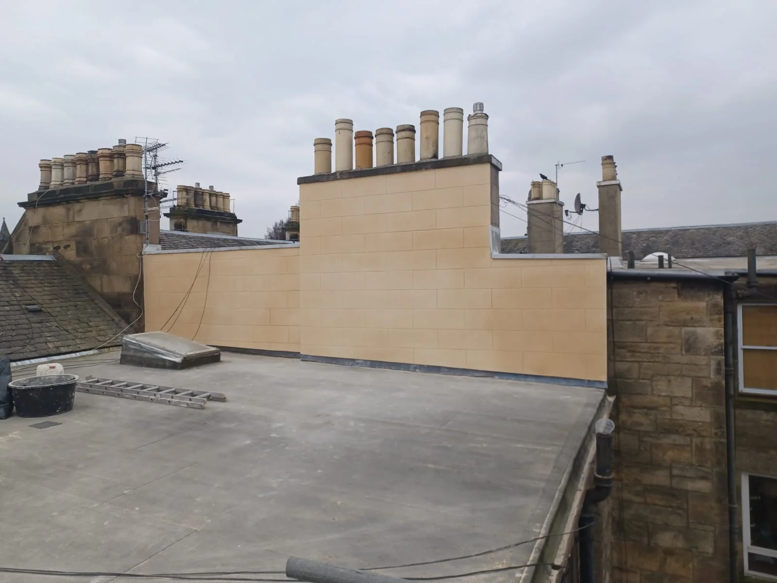 Rendered chimney stack and gable wall above a flat roof in Bellevue, Edinburgh