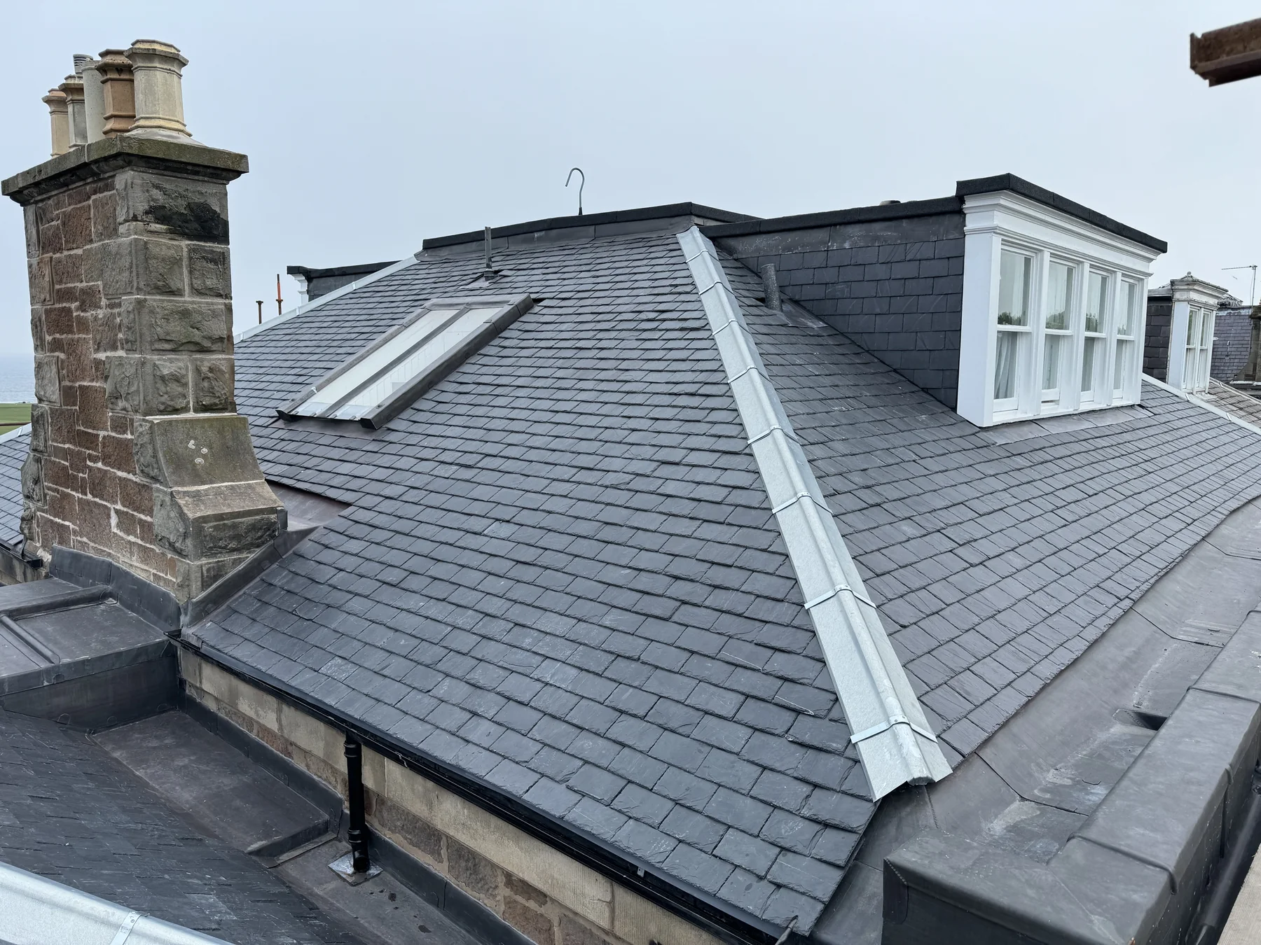 Spanish slate roof with lead ridge, dormer and stone chimney head on a property at Cromwell Road, Edinburgh
